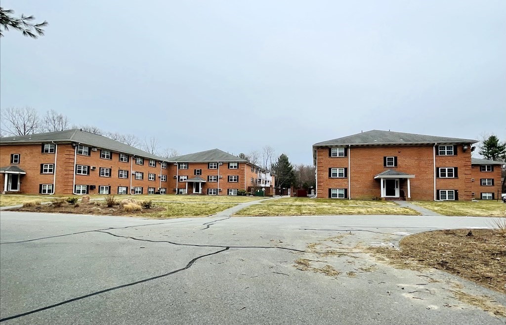 63 Leonard Road, Unit 63 Boxborough, MA 01719 - Photo 2 of 17 a front view of a house with a yard