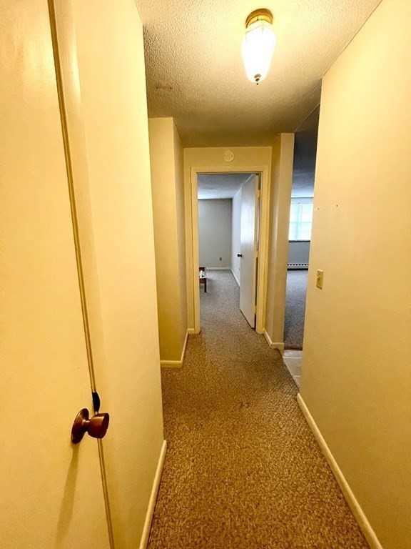 63 Leonard Road, Unit 63 Boxborough, MA 01719 - Photo 7 of 17 a view of a hallway with a bathroom
