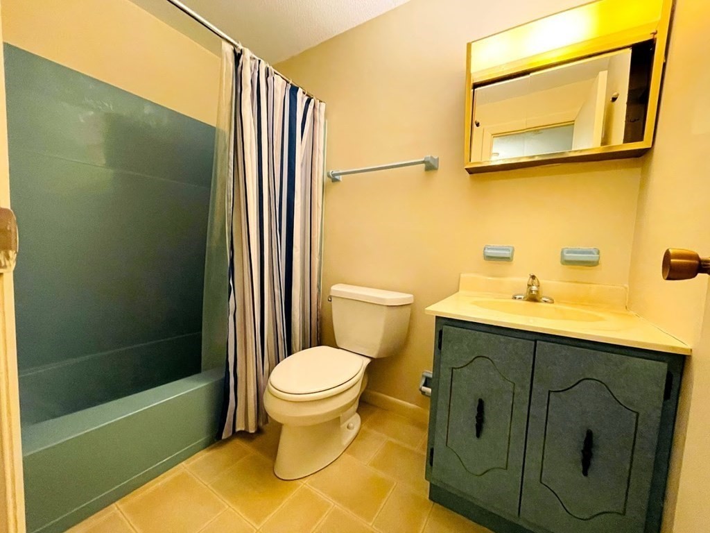 63 Leonard Road, Unit 63 Boxborough, MA 01719 - Photo 8 of 17 a bathroom with a sink and a mirror