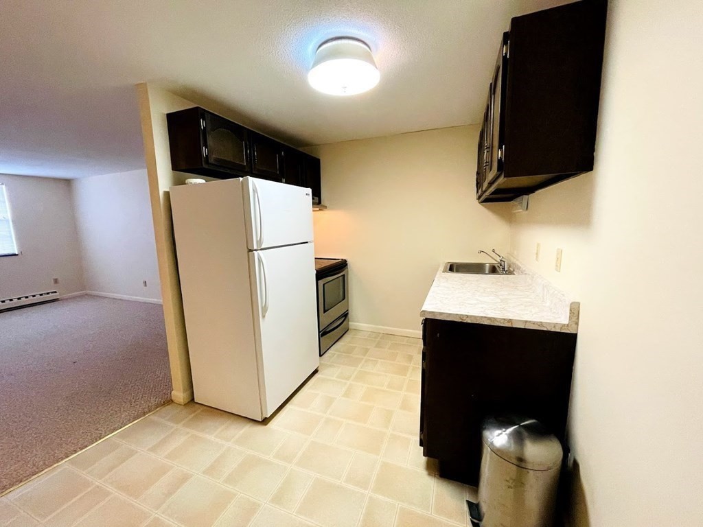 63 Leonard Road, Unit 63 Boxborough, MA 01719 - Photo 9 of 17 a bathroom with a sink toilet and mirror