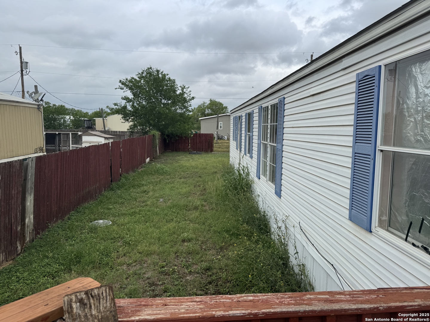 509 Maple Street Jourdanton, TX 78026 - Photo 12 of 14 a backyard of a house with lots of green space