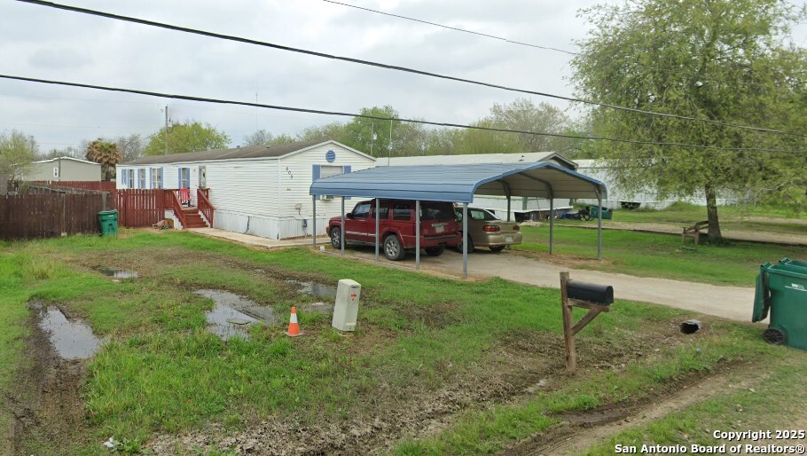 509 Maple Street Jourdanton, TX 78026 - Photo 14 of 14 a view of a house with a yard