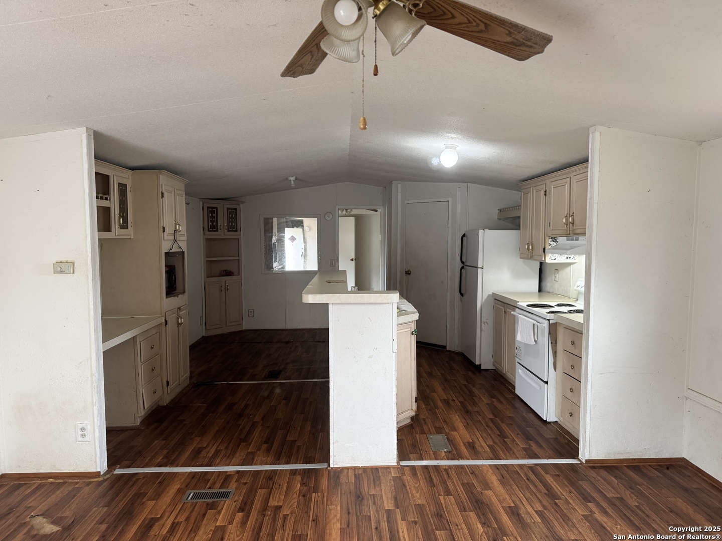 509 Maple Street Jourdanton, TX 78026 - Photo 3 of 14 a kitchen with refrigerator and cabinets