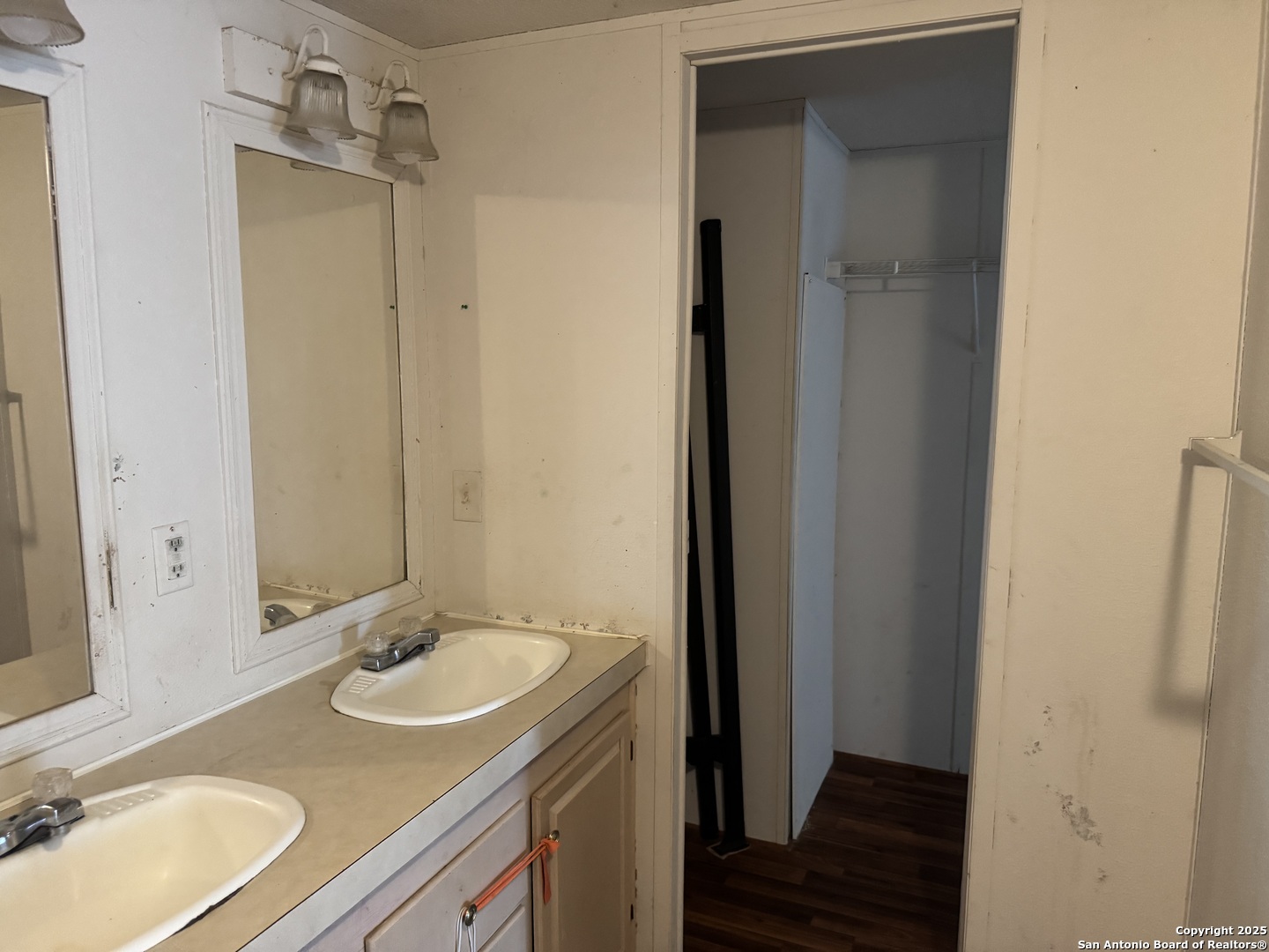 509 Maple Street Jourdanton, TX 78026 - Photo 7 of 14 a bathroom with a sink and a mirror