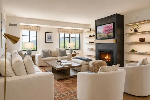 a living room with furniture fireplace and window