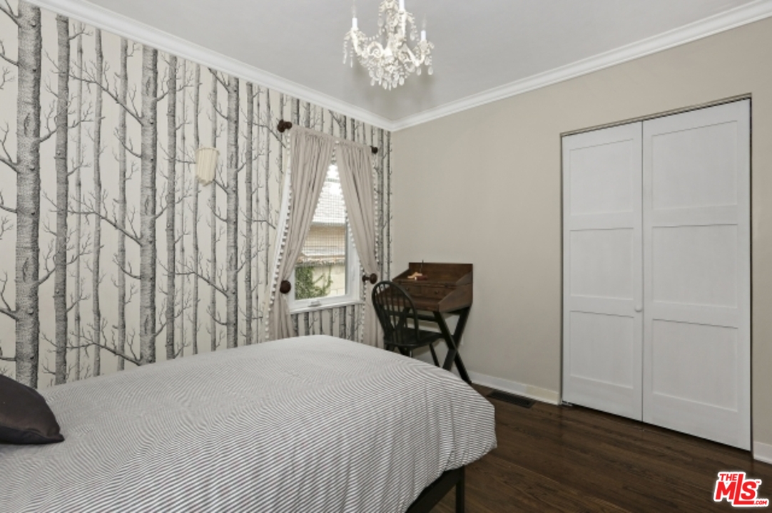 3801 Roderick Road Los Angeles, CA 90065 - Photo 22 of 38 a bedroom with a bed and a chandelier