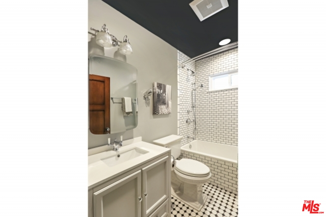 3801 Roderick Road Los Angeles, CA 90065 - Photo 23 of 38 a bathroom with a sink toilet a shower and a mirror