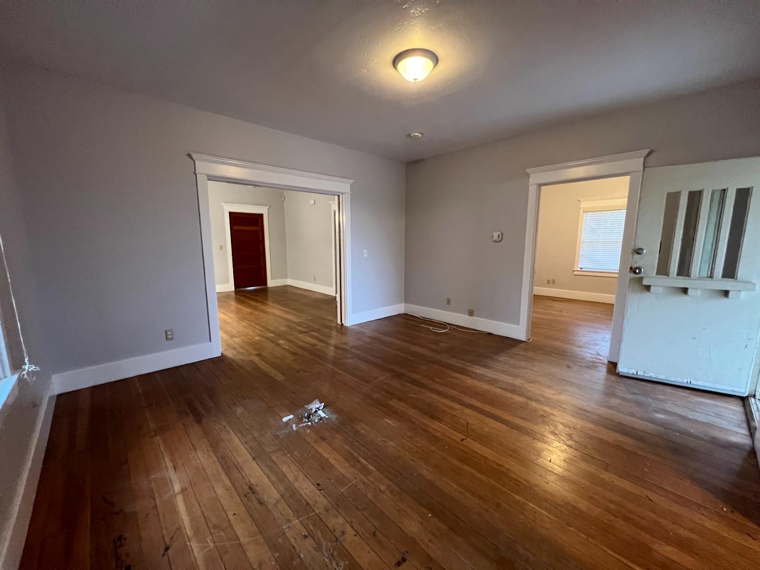 19076 East Central Avenue Reedley, CA 93654 - Photo 11 of 16 wooden floor in an empty room with a window