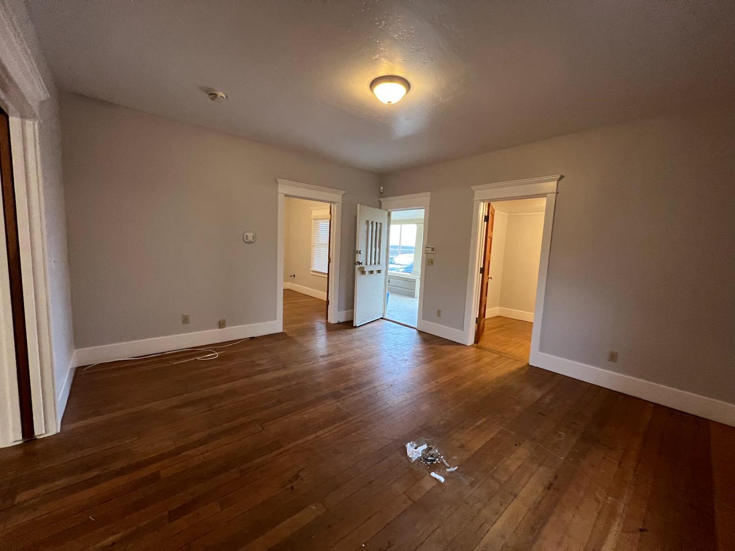 19076 East Central Avenue Reedley, CA 93654 - Photo 12 of 16 an empty room with wooden floor and natural light