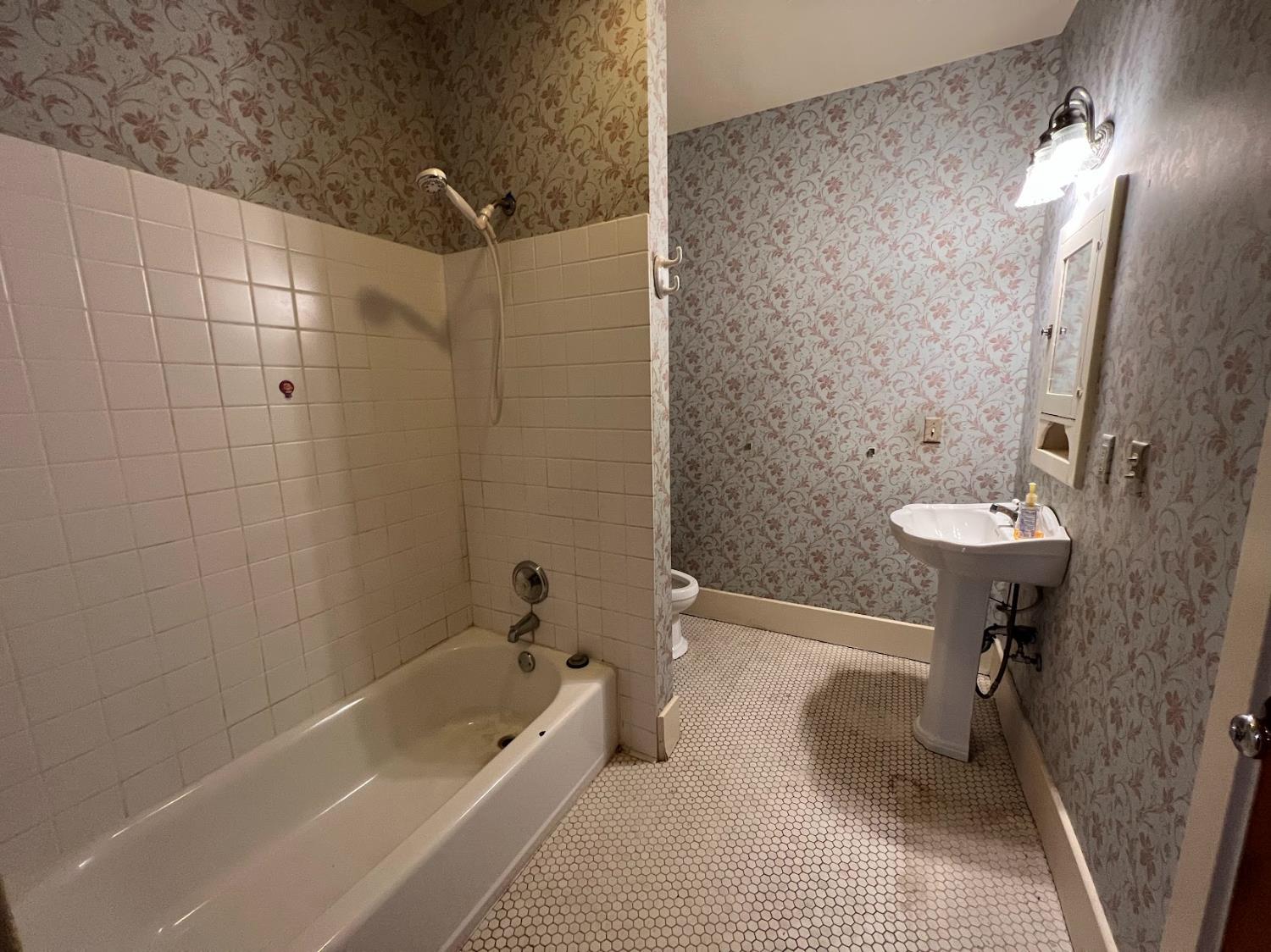19076 East Central Avenue Reedley, CA 93654 - Photo 13 of 16 a bathroom with a sink a toilet a mirror and shower