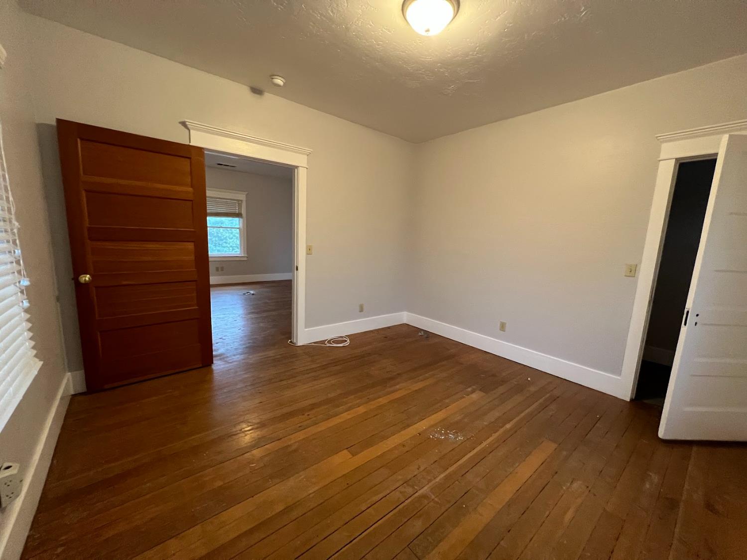 19076 East Central Avenue Reedley, CA 93654 - Photo 14 of 16 an empty room with wooden floor and closet