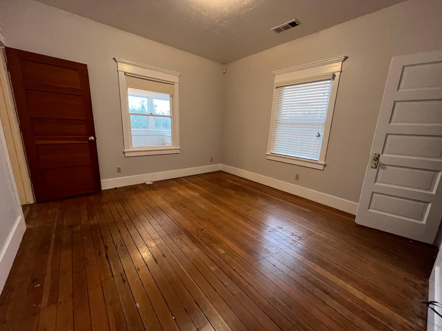 19076 East Central Avenue Reedley, CA 93654 - Photo 15 of 16 an empty room with wooden floor and windows