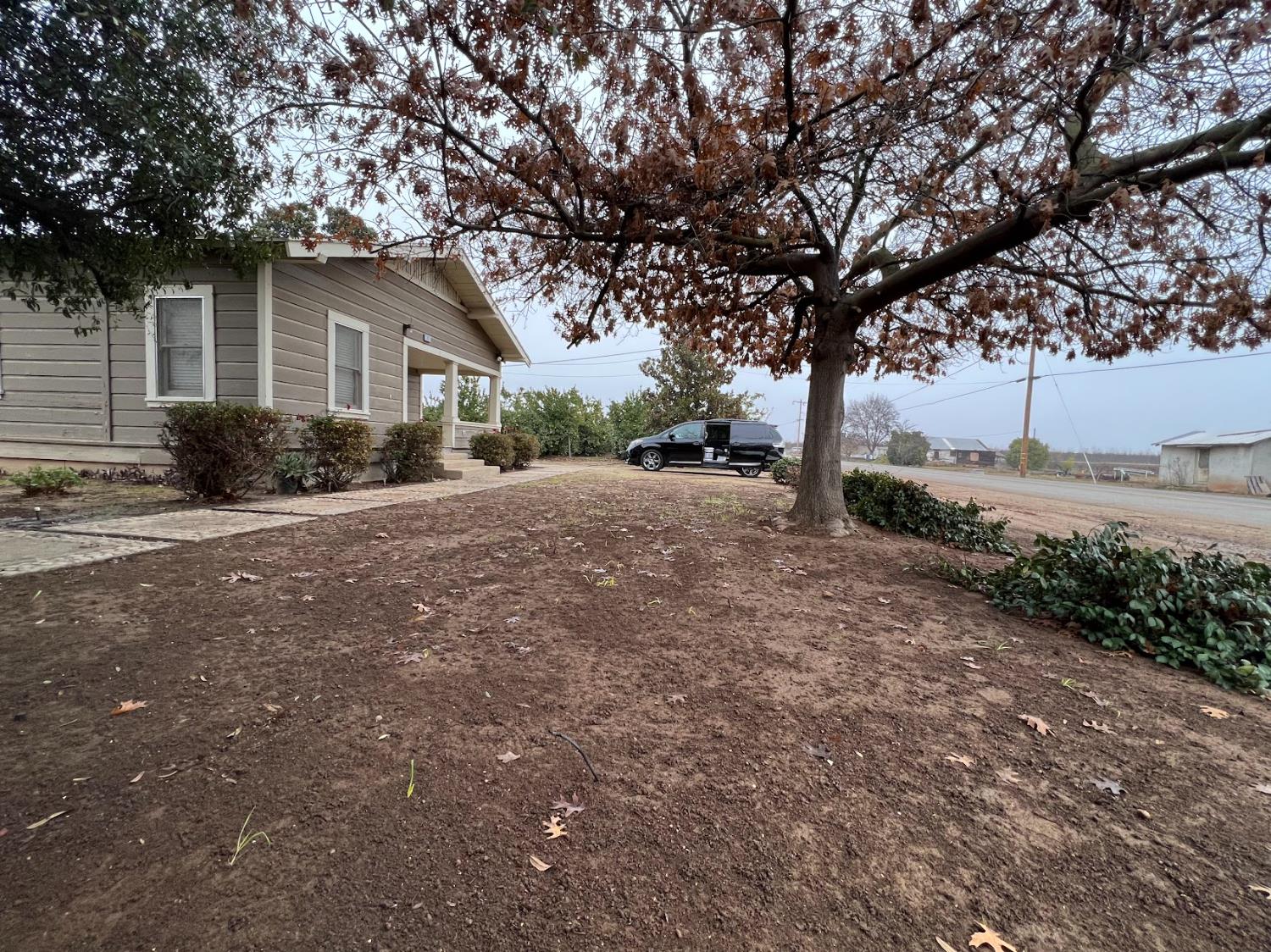 19076 East Central Avenue Reedley, CA 93654 - Photo 5 of 16 a view of a house with a yard covered in snow
