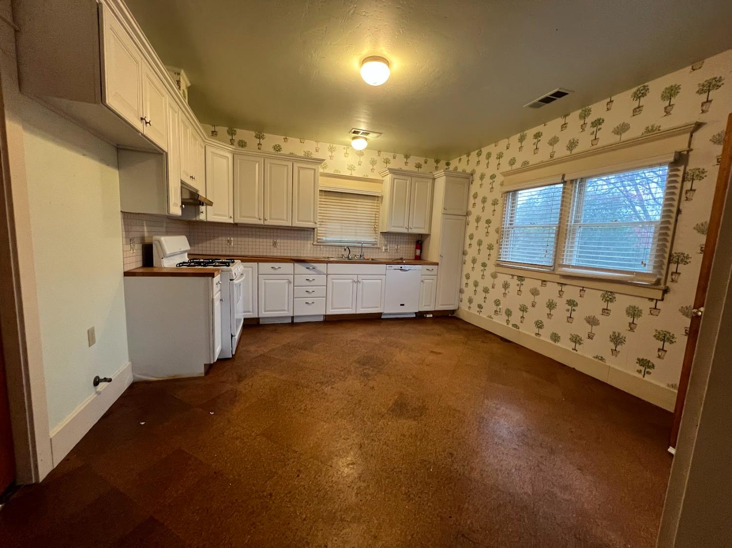 19076 East Central Avenue Reedley, CA 93654 - Photo 7 of 16 a large kitchen with a stove a sink dishwasher and a refrigerator