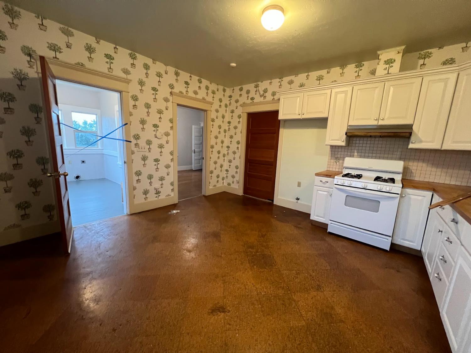 19076 East Central Avenue Reedley, CA 93654 - Photo 8 of 16 a view of a kitchen with flat screen tv and refrigerator
