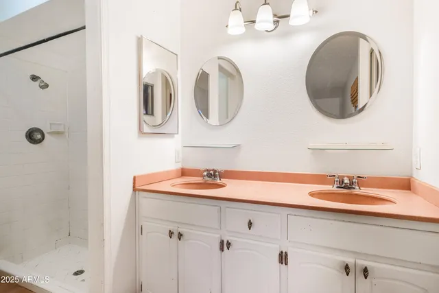 a bathroom with a double vanity sink and a mirror