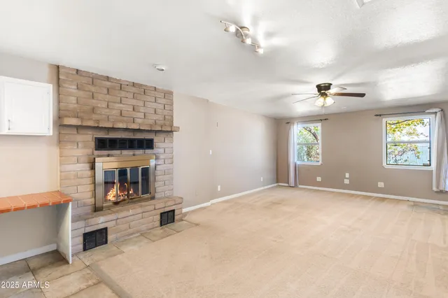 a view of an empty room with a fireplace