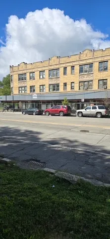 a front view of a building with a yard