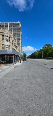 a view of a large building with a big yard