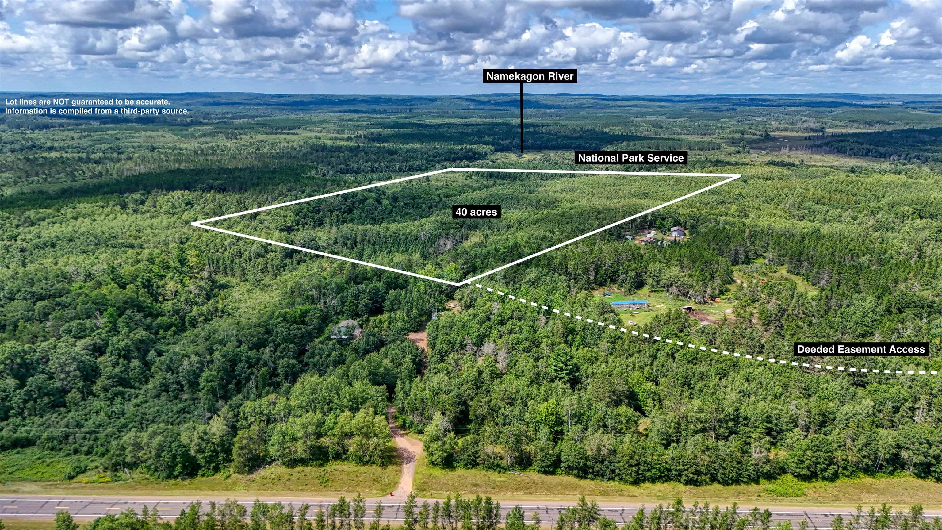 View of property location with a heavily wooded area and property parcel outlined