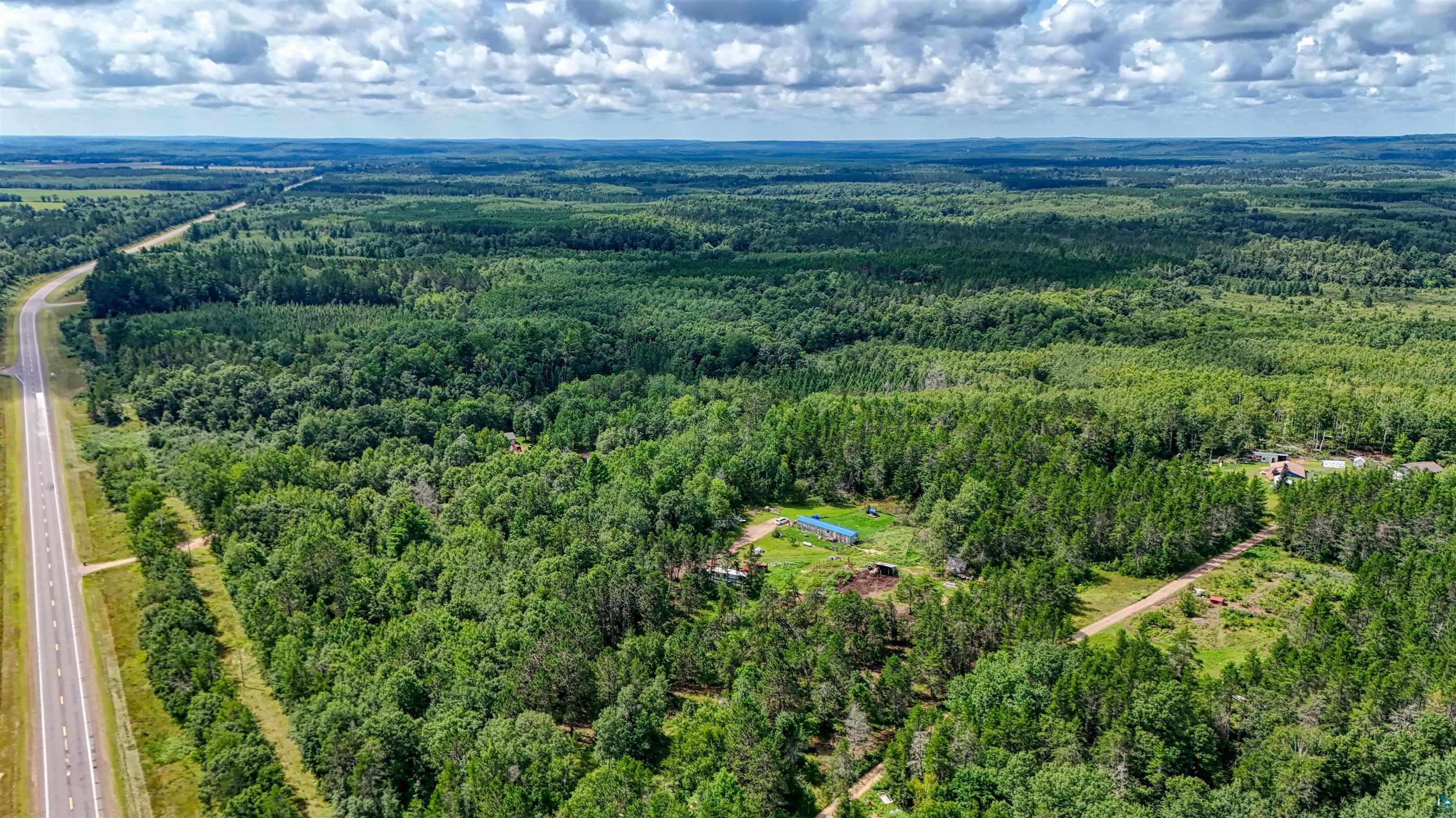 63 Highway 63 Springbrook, WI 54875 - Photo 2 of 15 Aerial view of property and surrounding area featuring a forest