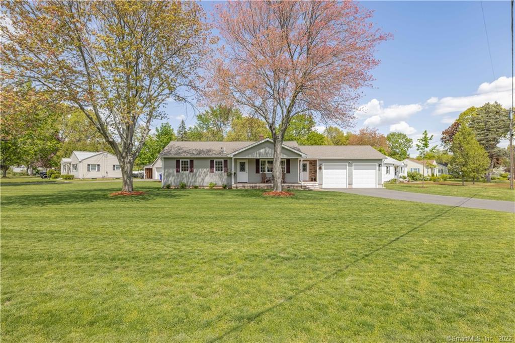 a view of house with outdoor space and garden