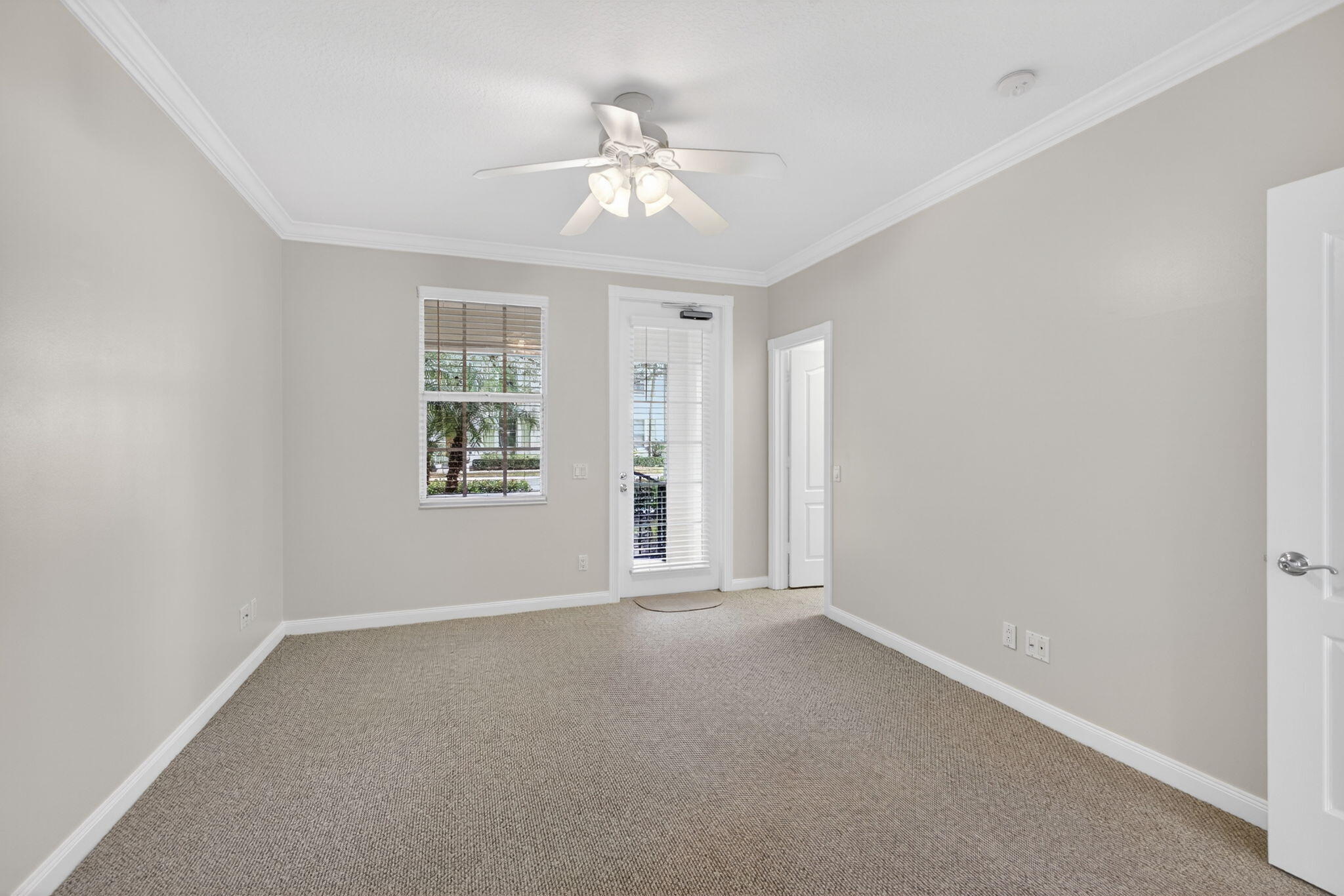 4118 Parkside Drive Jupiter, FL 33458 - Photo 14 of 73 an empty room with chandelier fan and windows
