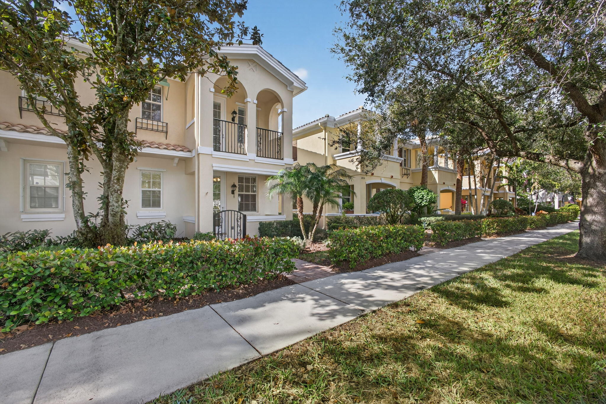 4118 Parkside Drive Jupiter, FL 33458 - Photo 2 of 73 a front view of a house with a garden