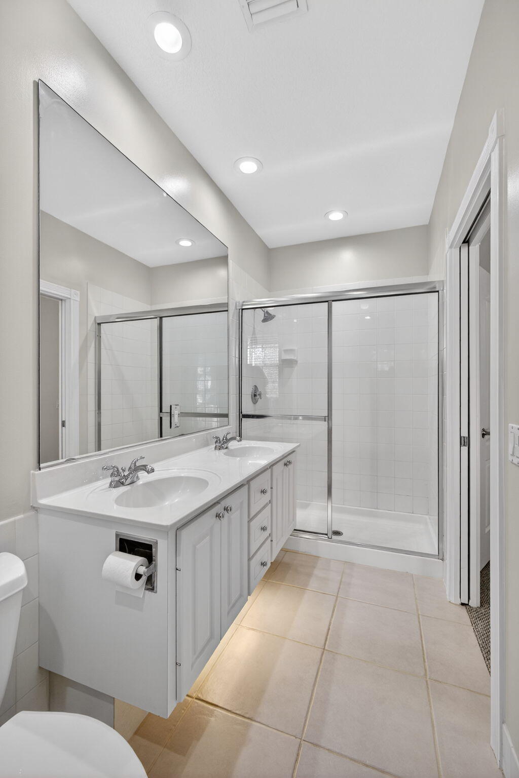 4118 Parkside Drive Jupiter, FL 33458 - Photo 31 of 73 a large bathroom with a granite countertop sink a toilet a mirror and shower