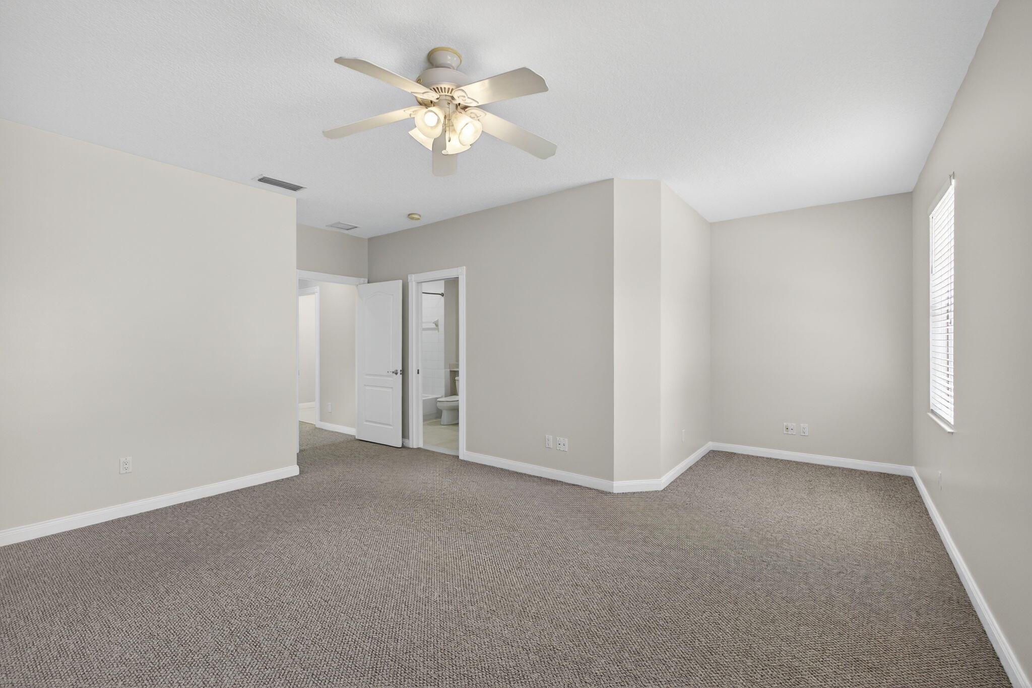 4118 Parkside Drive Jupiter, FL 33458 - Photo 37 of 73 an empty room with a chandelier fan and windows