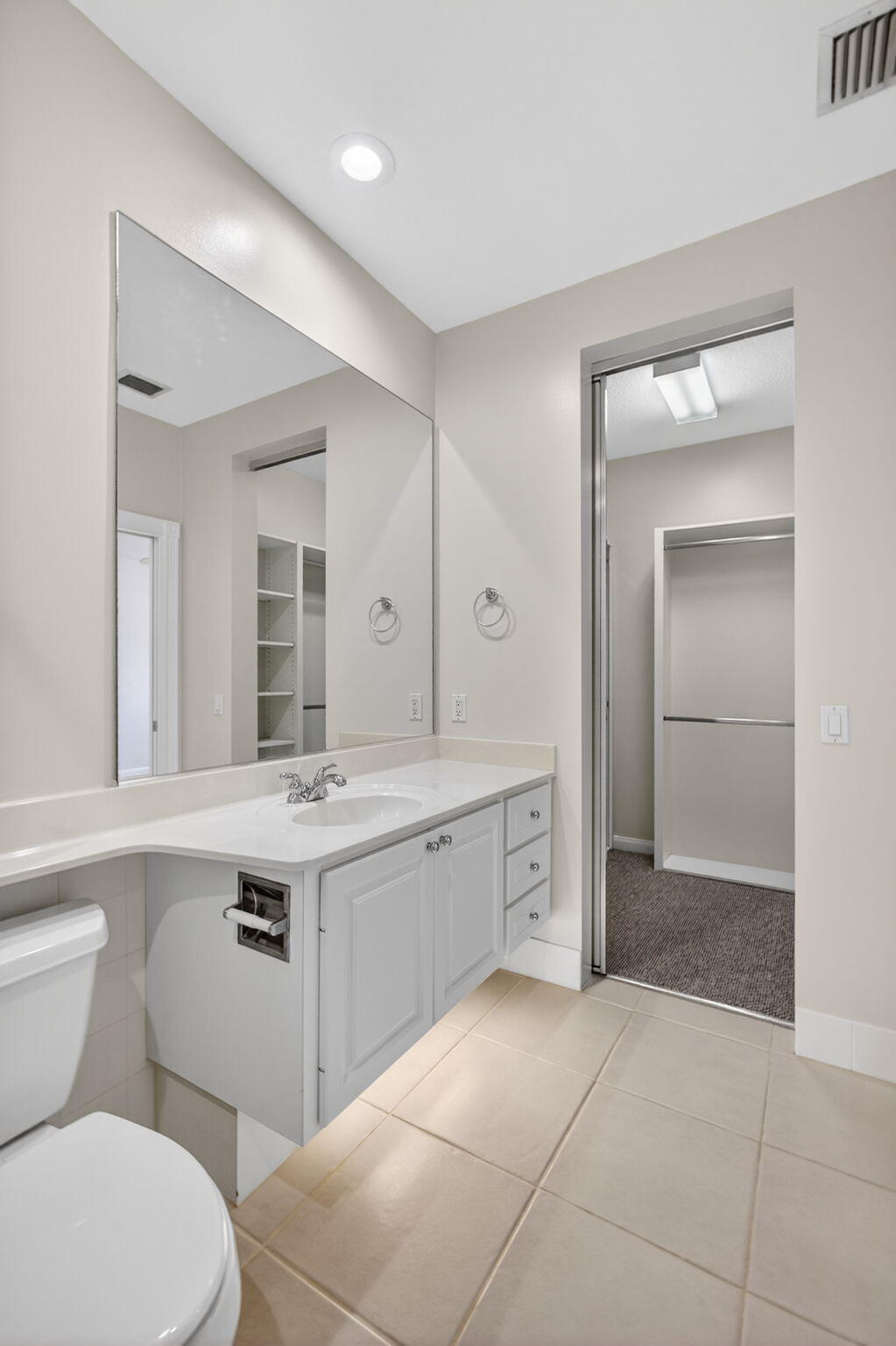 4118 Parkside Drive Jupiter, FL 33458 - Photo 41 of 73 a spacious bathroom with a toilet sink and mirror