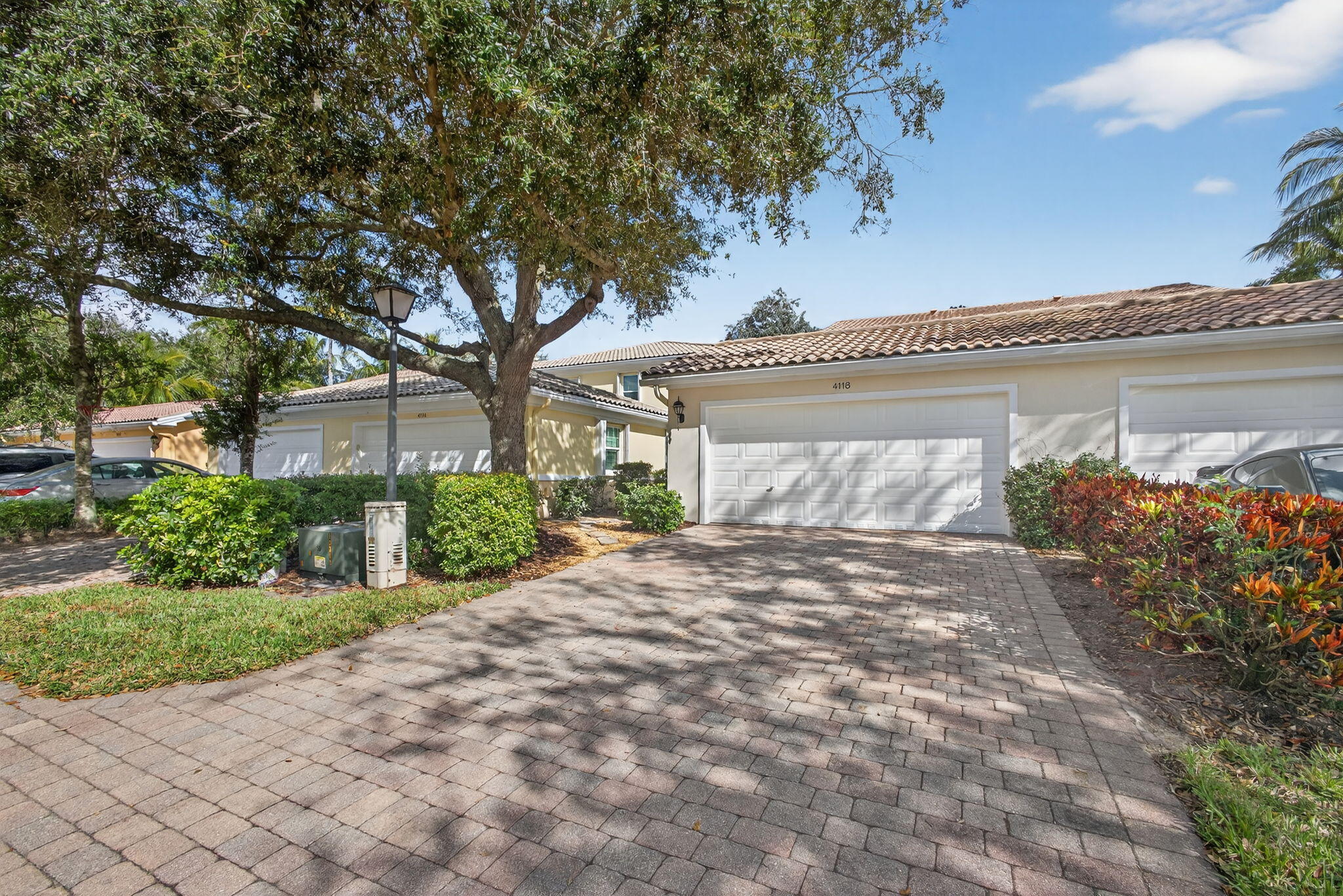 4118 Parkside Drive Jupiter, FL 33458 - Photo 50 of 73 a front view of a house with a yard and garage