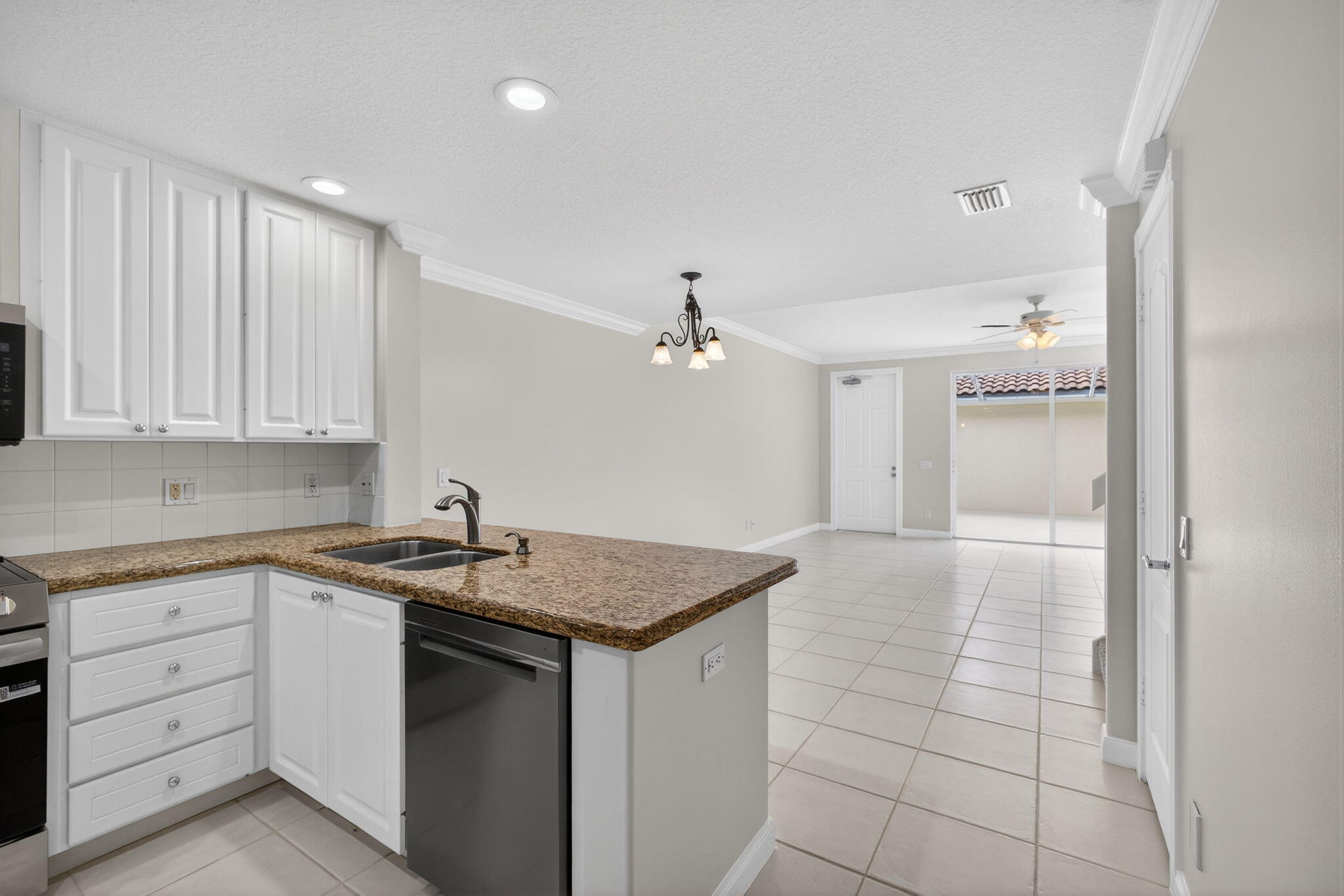 4118 Parkside Drive Jupiter, FL 33458 - Photo 7 of 73 a kitchen with a sink dishwasher and white cabinets with wooden floor