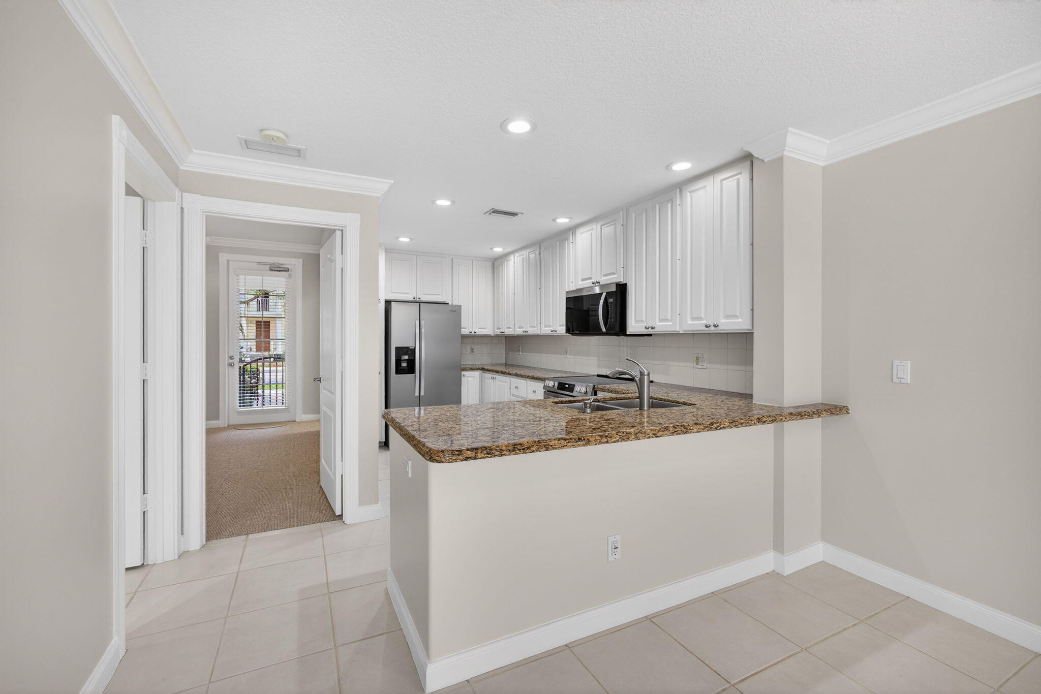 4118 Parkside Drive Jupiter, FL 33458 - Photo 8 of 73 a kitchen with stainless steel appliances granite countertop a sink and cabinets