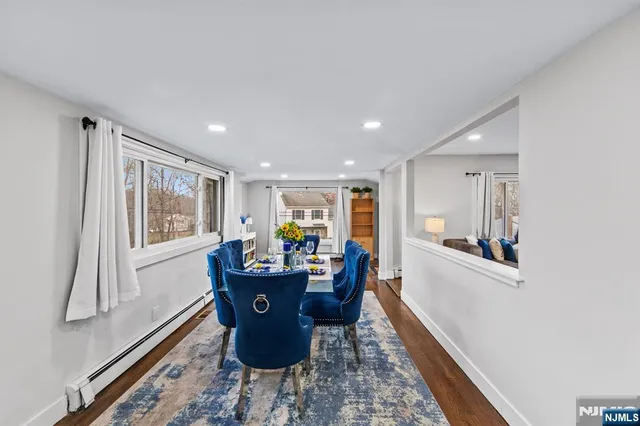 a dining room with furniture window and wooden floor