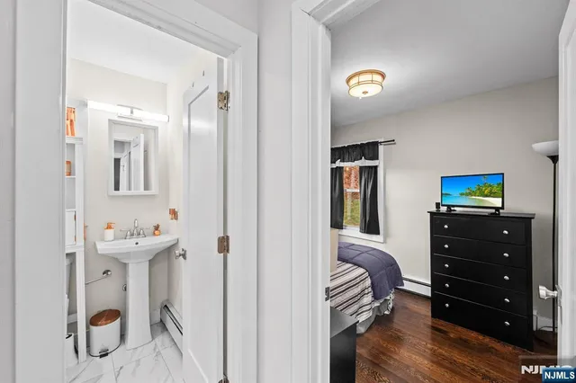 a bathroom with a sink mirror and a toilet