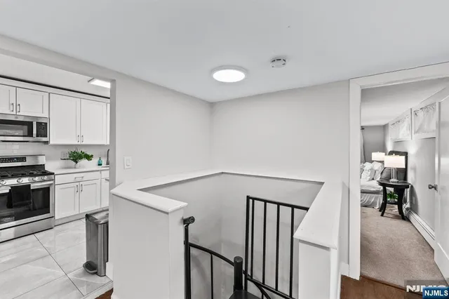 a view of staircase with lots of frames on wall