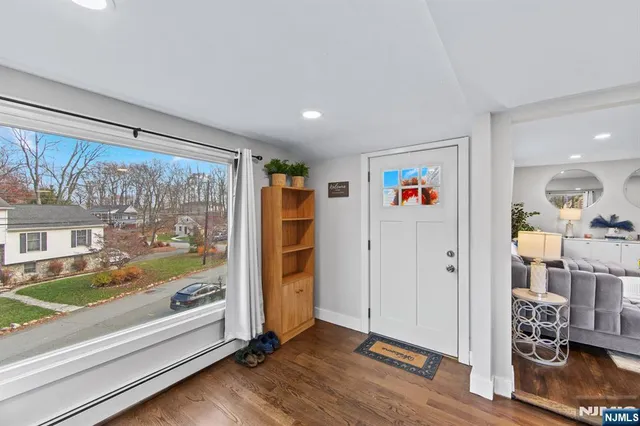 a view of an entryway with wooden floor and door