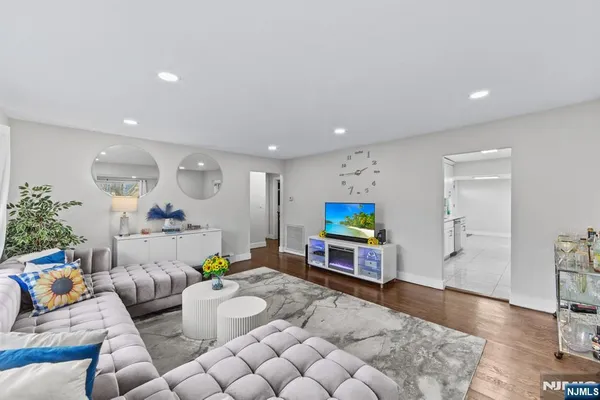 a kitchen with stainless steel appliances a sink a stove cabinets and a window