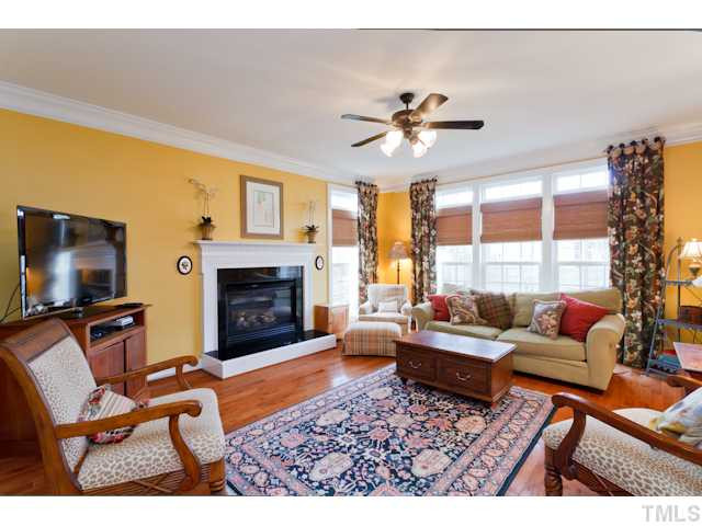 Bright Family Room is open to the Kitchen for easy entertaining! Glowing Hardwoods, Crown Molding, Ceiling Fan, Raised Heath Gas Fireplace & a great view of the back yard space. Den/Family/Great Room
