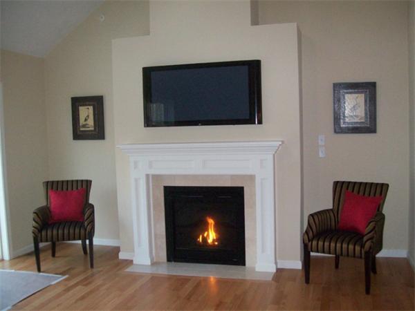 20 Riley Road, Unit 11 Lunenburg, MA 01462 - Photo 2 of 8 a living room with furniture a fireplace and a flat screen tv