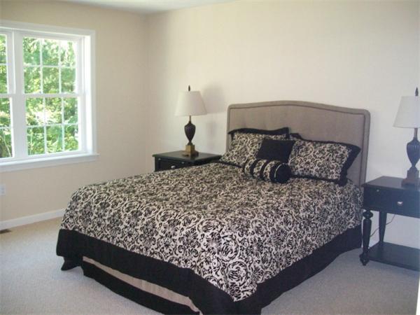 20 Riley Road, Unit 11 Lunenburg, MA 01462 - Photo 6 of 8 a bed sitting in a bedroom next to a window