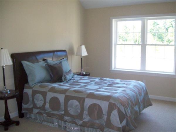 20 Riley Road, Unit 11 Lunenburg, MA 01462 - Photo 7 of 8 a bedroom with a bed and a window