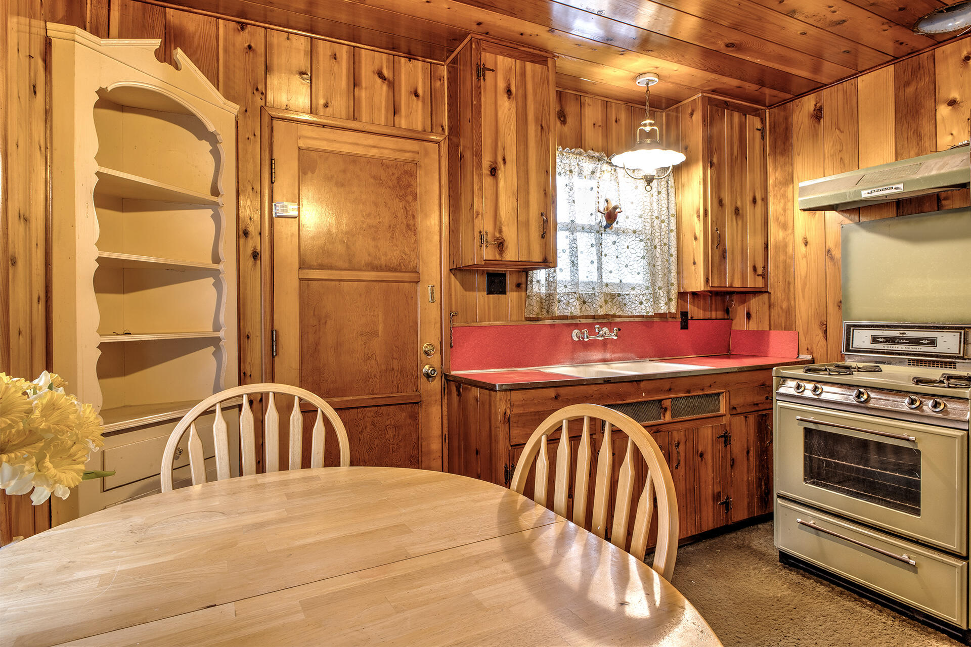 53250 Middleridge Drive Idyllwild, CA 92549 - Photo 17 of 30 a kitchen with stainless steel appliances granite countertop a dining table chairs and a refrigerator