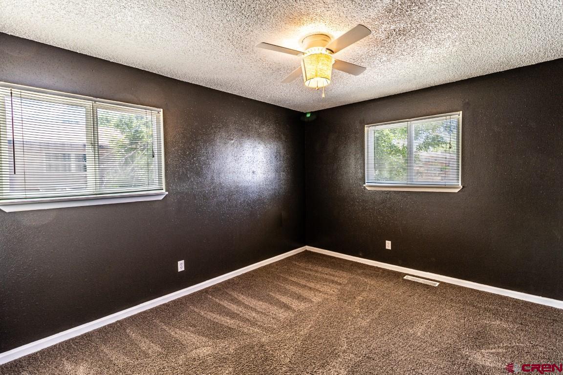 5705 Ravella Drive Farmington, NM 87402 - Photo 23 of 35 an empty room with windows and fan