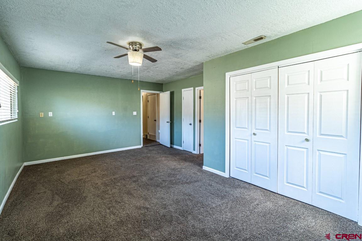 5705 Ravella Drive Farmington, NM 87402 - Photo 24 of 35 a view of an empty room with a ceiling fan