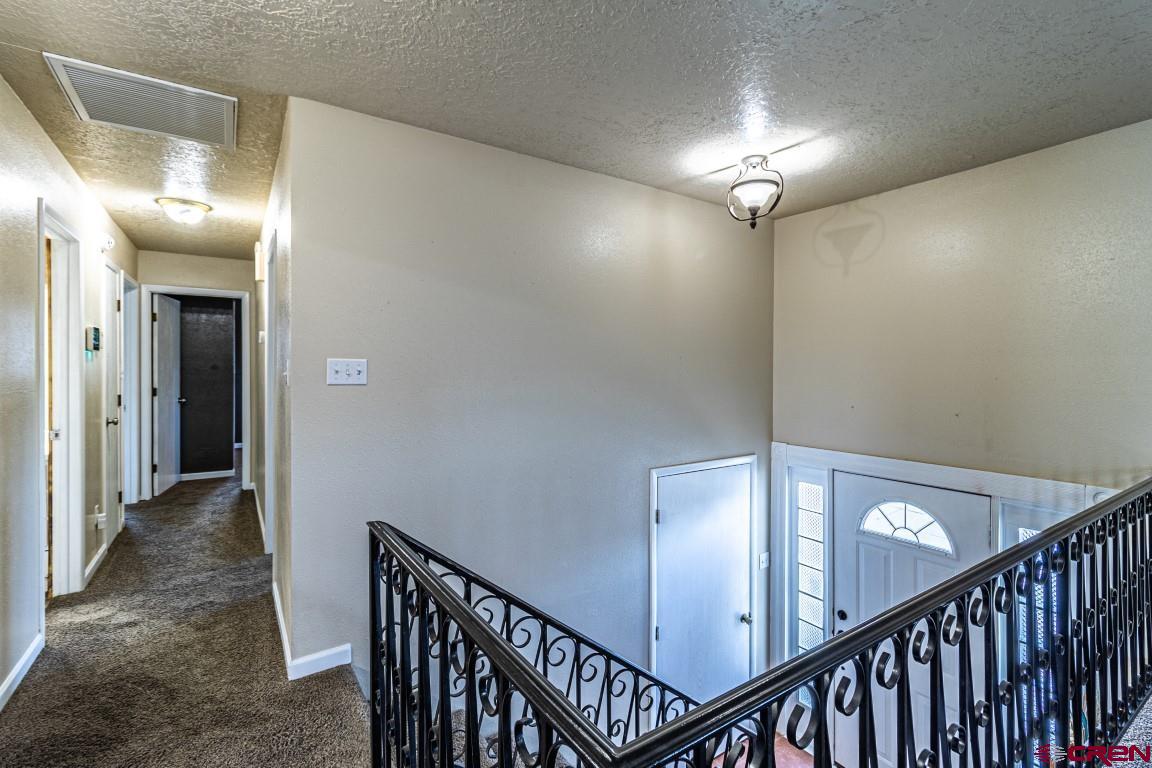 5705 Ravella Drive Farmington, NM 87402 - Photo 4 of 35 a view of a hallway with wooden floor