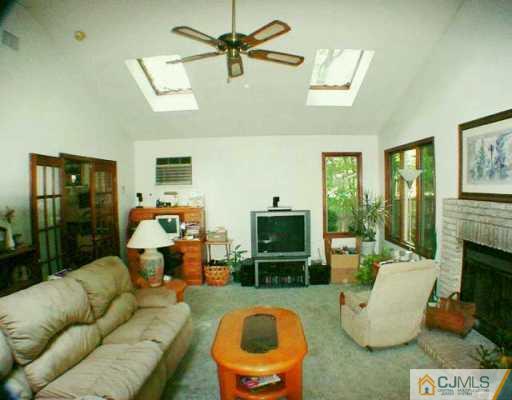 5 Conerly Road Somerset, NJ 08873 - Photo 4 of 8 a living room with furniture a fireplace and a flat screen tv