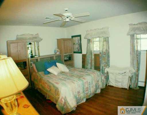 5 Conerly Road Somerset, NJ 08873 - Photo 6 of 8 a bedroom with a bed and wooden floor