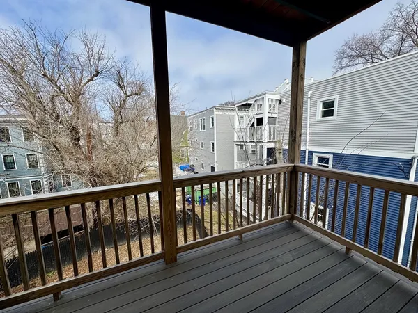 a view of a balcony with wooden floor